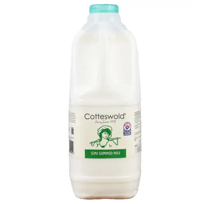 A white plastic bottle of cotteswold semi skimmed milk with a teal cap and green vintage label