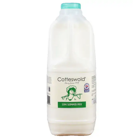 A white plastic bottle of cotteswold semi skimmed milk with a teal cap and green vintage label