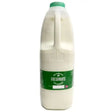A translucent plastic bottle of semi skimmed milk freshways with a green cap and label filled with white milk cotteswold