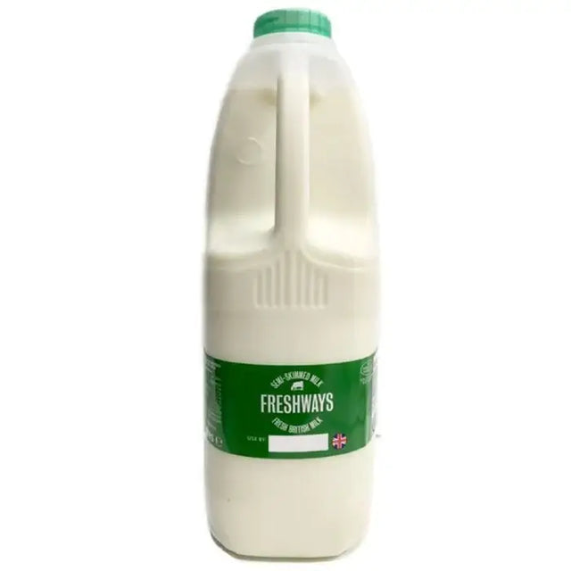 A translucent plastic bottle of semi skimmed milk freshways with a green cap and label filled with white milk cotteswold