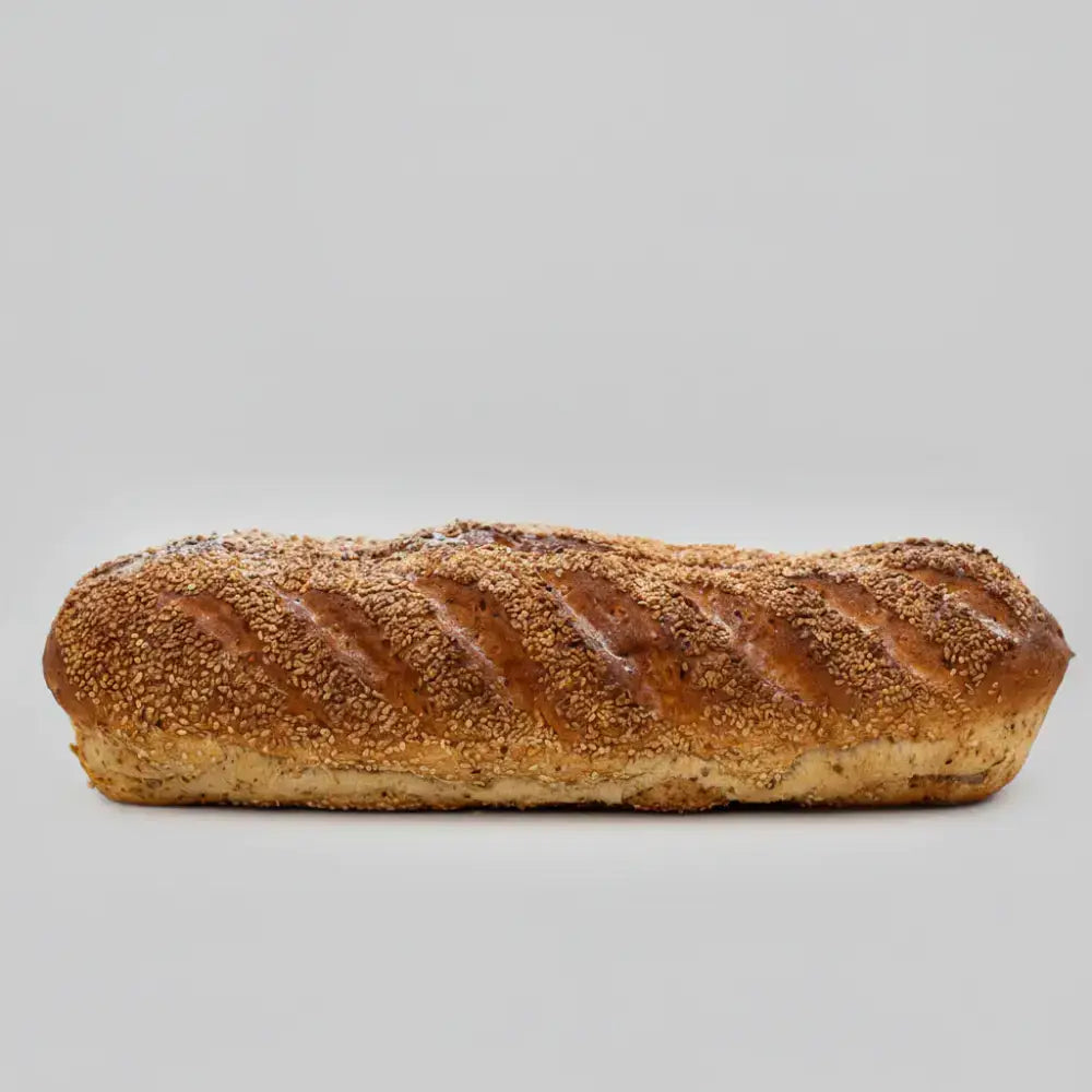 Golden brown sesame seed granary loaf with a scored crusty surface fresh seed granary bloomer bread