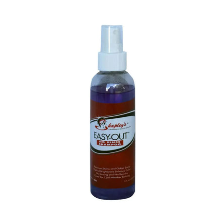 A clear plastic spray bottle with purple liquid shapley’s easy-out no rinse shampoo for minute clean ups on horse’s coat