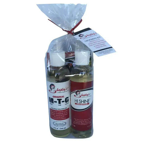 A clear bag tied with red ribbon holds two glass bottles of hapleys grooming kit for equestrian horses care
