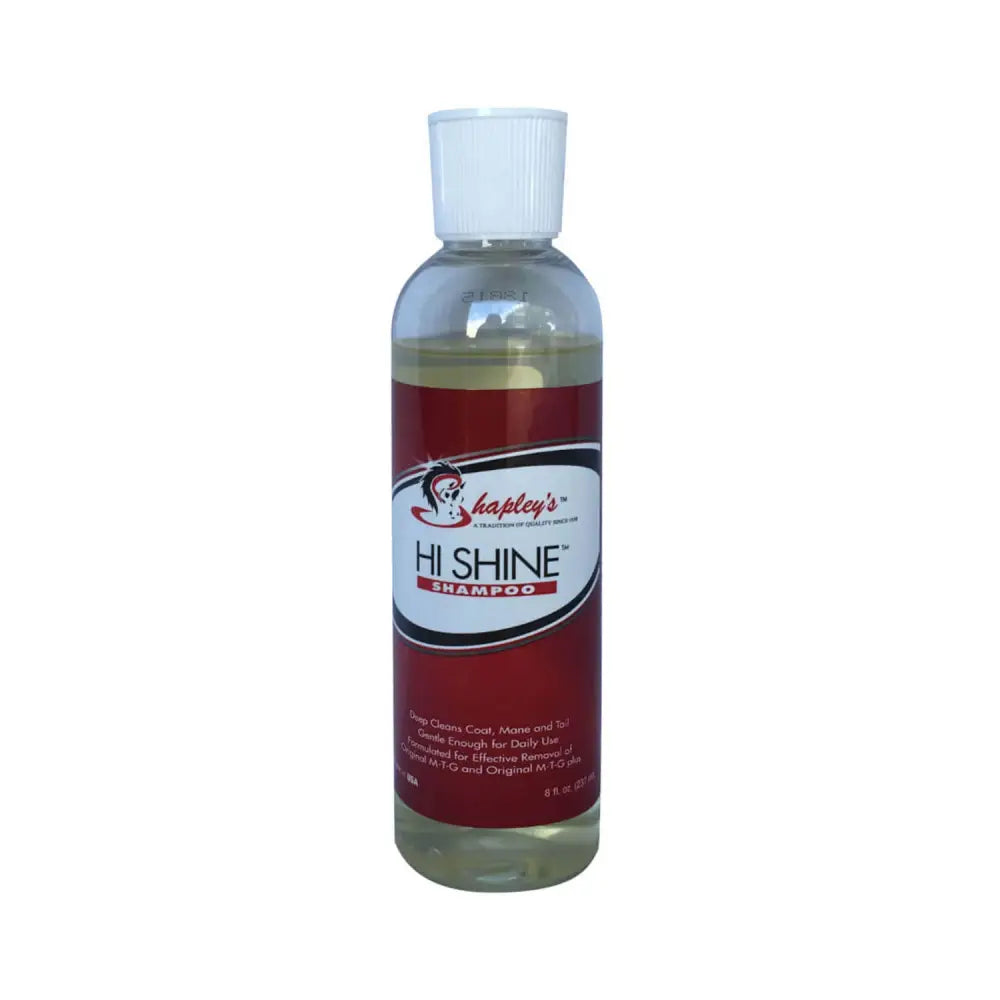 A clear plastic bottle with white cap of shapleys high shine red labeled shampoo gently deep cleans horse coats