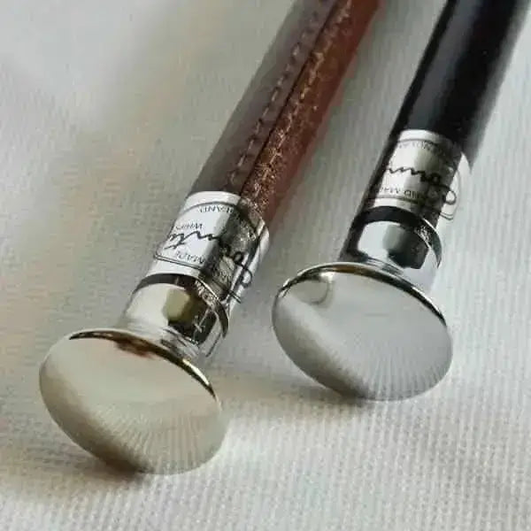 Two elegant handmade showing canes with cane chrome flat tops, leather grips in brown and black, and silver caps