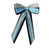 A shimmering silver and light blue satin showquest hairbow with beaded edges for a finishing showring touch