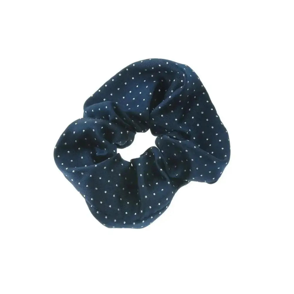 A navy blue showquest pin spot scrunchie with white polka dots made from jacquard woven fabric