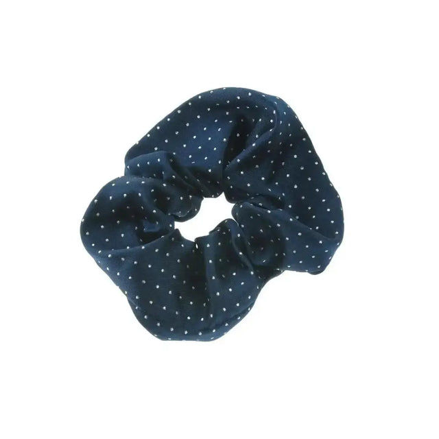 A navy blue showquest pin spot scrunchie with white polka dots made from jacquard woven fabric