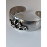Silver steed herd bangle featuring a silver metal cuff bracelet with a 3d detailed horse figurine design perfect for equestrian jewelry