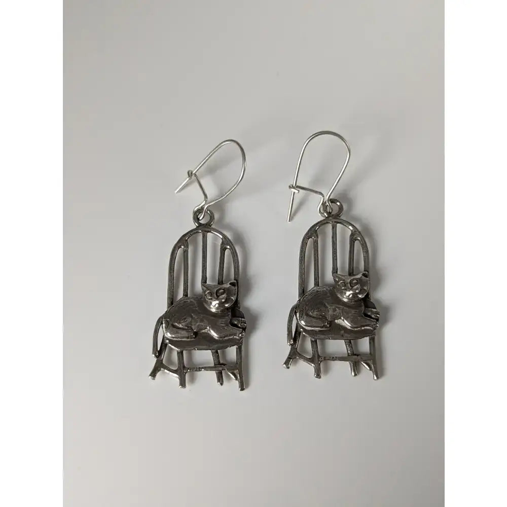 Silver steed handmade silver chair dropped earrings featuring polished metallic finish and intricate cat-on-chair design