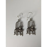 Silver steed handmade silver chair dropped earrings featuring polished metallic finish and intricate cat-on-chair design