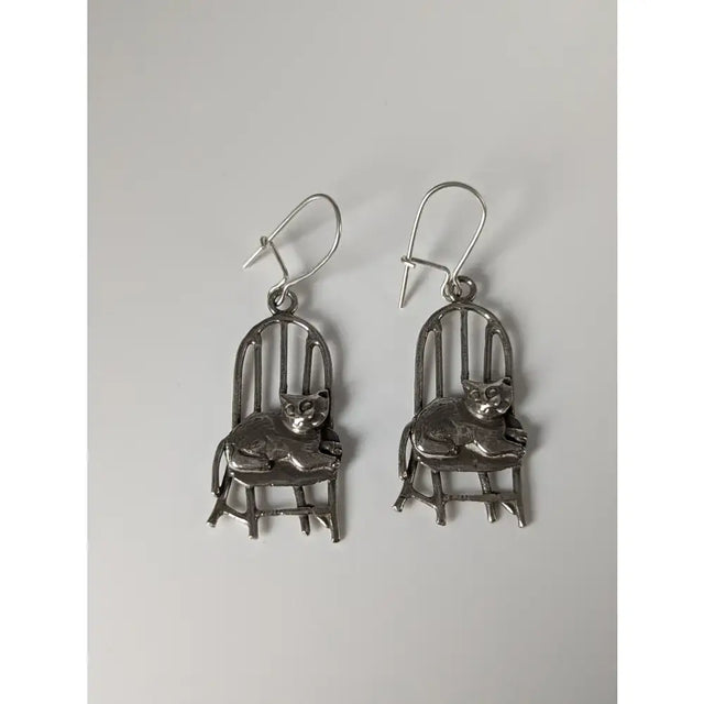 Silver steed handmade silver chair dropped earrings featuring polished metallic finish and intricate cat-on-chair design
