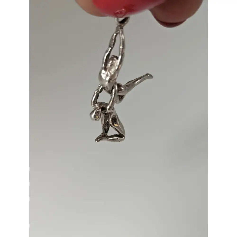 Silver steed acrobats sterling silver pendant featuring two acrobats in a dynamic intertwined pose