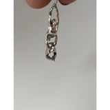 Silver steed acrobats silver pendant features a silver-toned sterling silver chain with an abstract human figure design