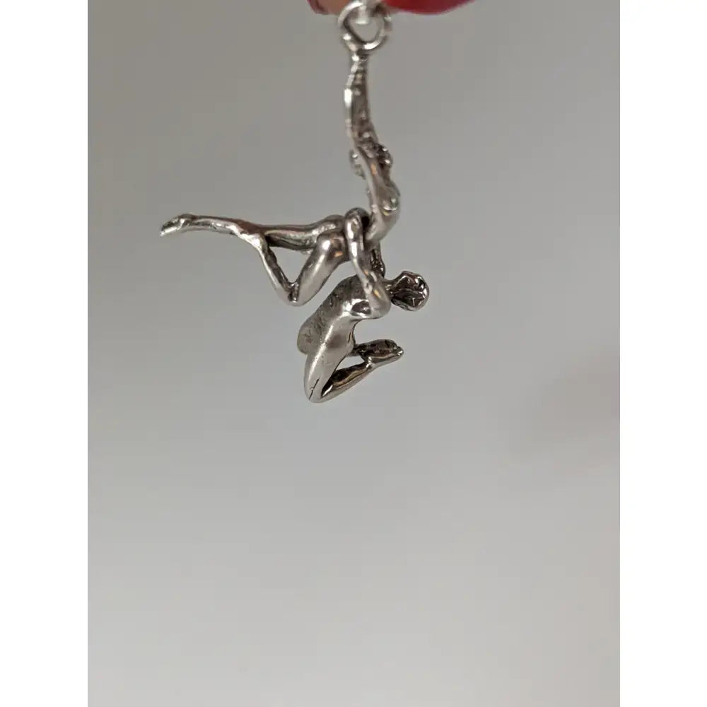 Silver steed acrobats sterling silver pendant featuring two figures in an acrobatic pose in silver tone
