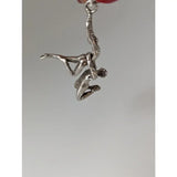 Silver steed acrobats sterling silver pendant featuring two figures in an acrobatic pose in silver tone