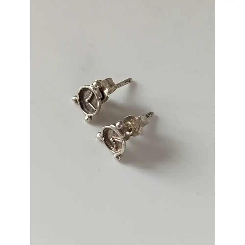 Silver steed alarm clock stud earrings with polished metallic finish and intricate mercedes-benz logo detailing