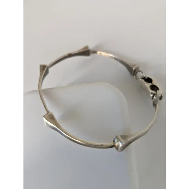 Silver steed sterling silver hoofnails bangle with angular bone-like segments and clasp with three black accents