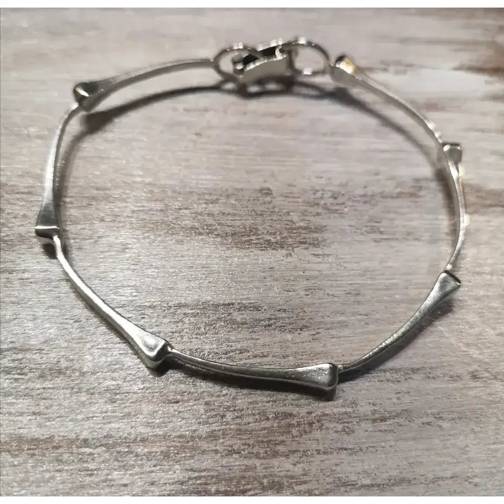 Silver steed sterling silver bone-shaped hoofnails bangle with sleek minimalist design and secure clasp