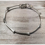 Silver steed sterling silver bone-shaped hoofnails bangle with sleek minimalist design and secure clasp