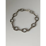 Silver steed horseshoe silver bracelet with polished metallic finish and detailed nailhead texture on horse hoof links