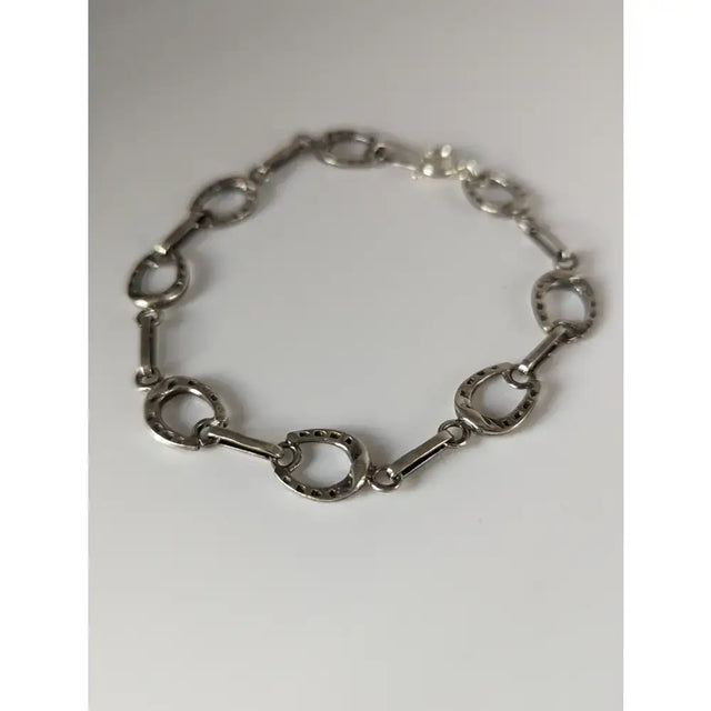 Silver steed horseshoe silver bracelet with polished metallic finish in a horse hoof link design