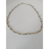 Silver steed snaffle necklace with silver and gold-tone chain and distinctive articulated equestrian link design