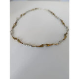 A two-tone silver and gold snaffle necklace from silver steed with sleek interlocking equestrian design