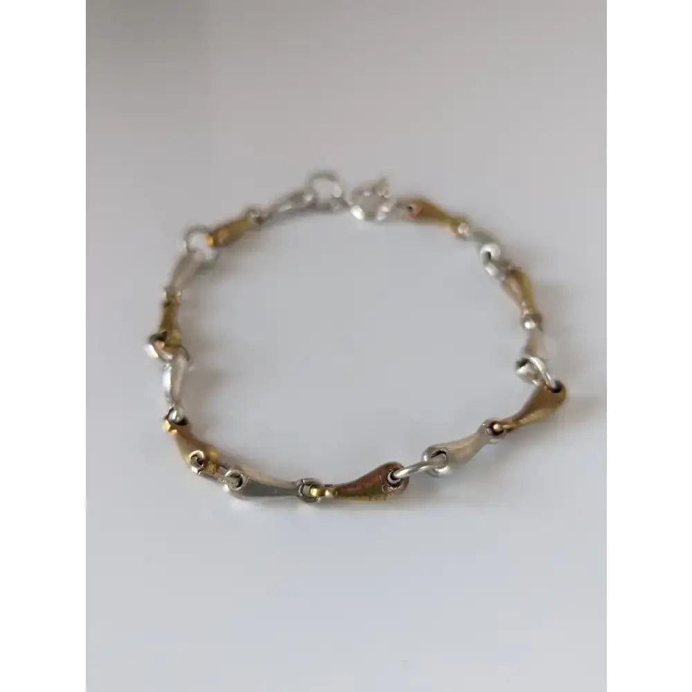 Silver steed snaffles bracelet with delicate silver and gold two-tone chain featuring sleek interlocking links