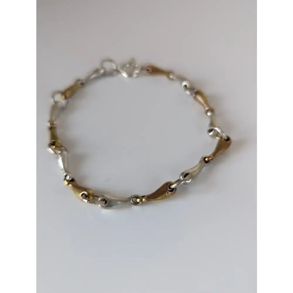 Silver steed snaffles bracelet with delicate silver and gold two-tone chain and interlocking links design