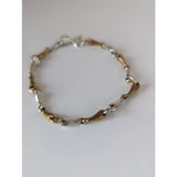 Silver steed snaffles bracelet with delicate silver and gold two-tone chain and interlocking links design