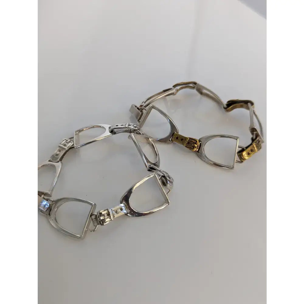 Silver steed stirrups bracelet with silver and gold-tone horsebit design and sparkling diamond accents in equestrian style