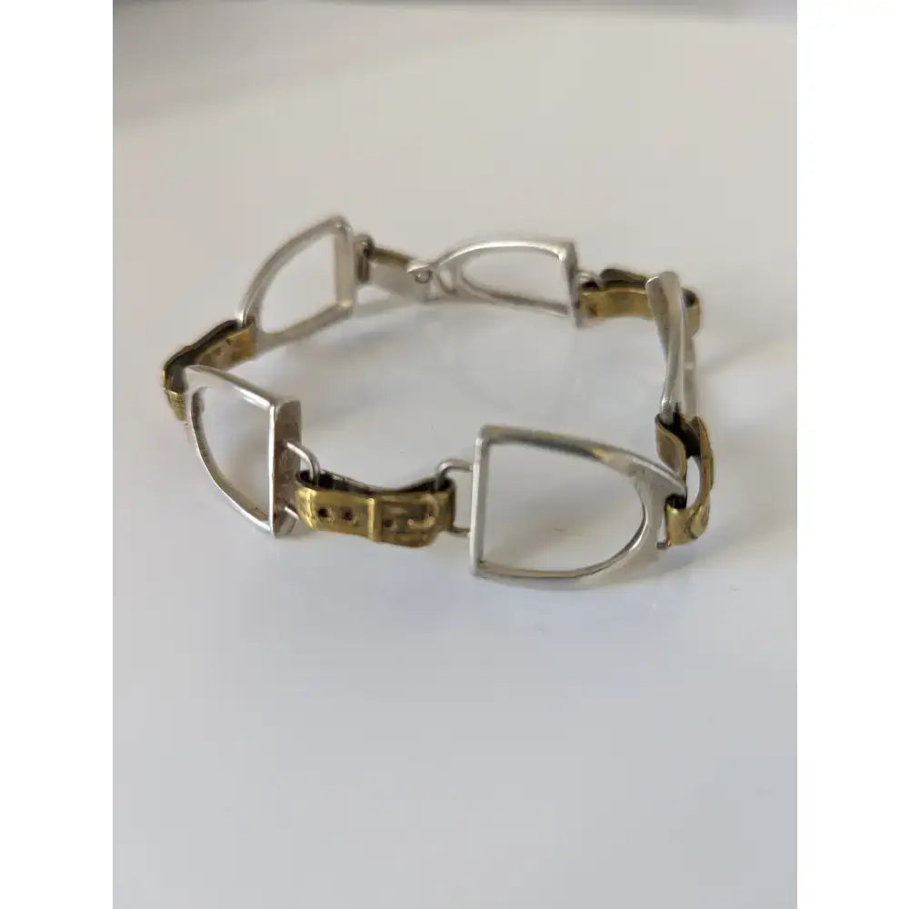 Silver steed stirrups bracelet with silver and gold toned horsebit style metal links in equestrian design