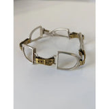 Silver steed stirrups bracelet with silver and gold toned horsebit style metal links in equestrian design