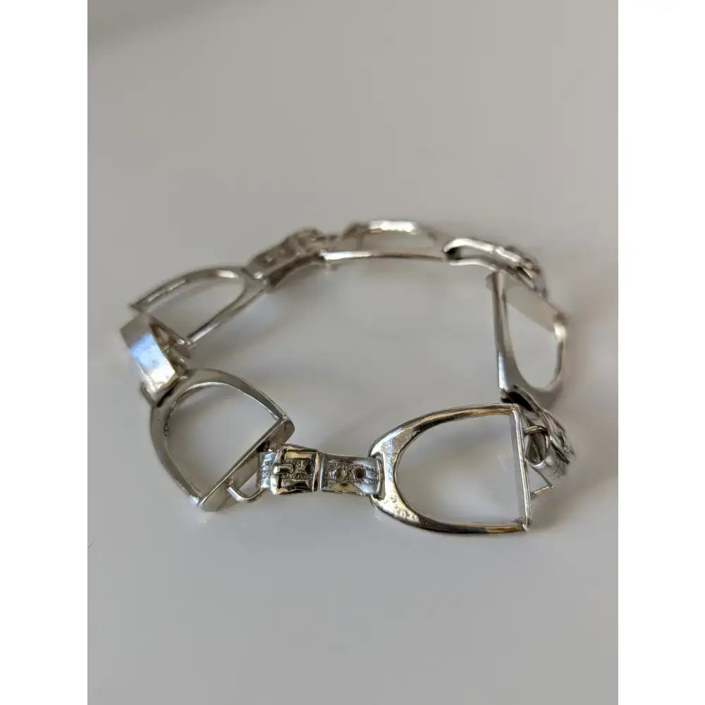Silver steed stirrups bracelet with polished silver horsebit links and detailed engraved clasp in equestrian design