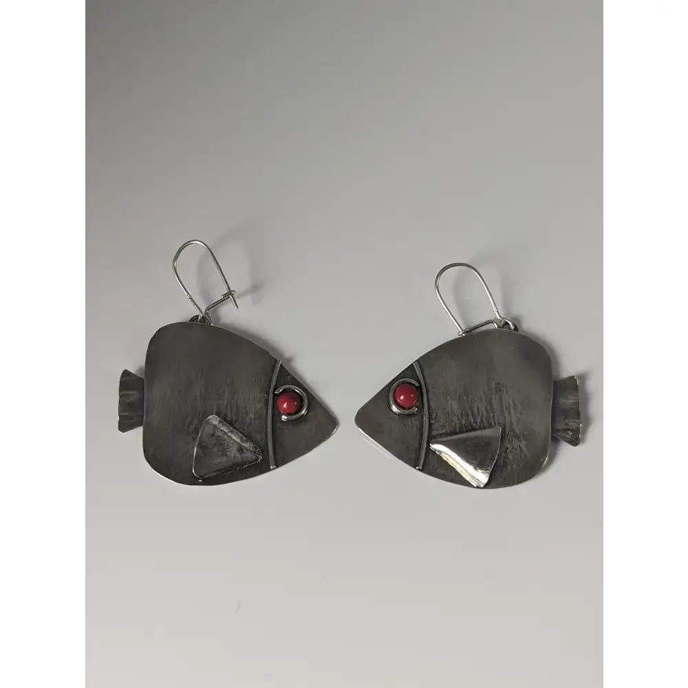 Silver steed angel fish dropped earrings featuring silver fish shape with red gemstone eyes and textured fins
