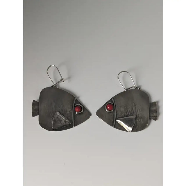 Silver steed angel fish dropped earrings featuring silver fish shape with red gemstone eyes and textured fins