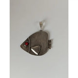 Silver steed angel fish silver pendant featuring a silver fish shape with a red gemstone eye and textured body