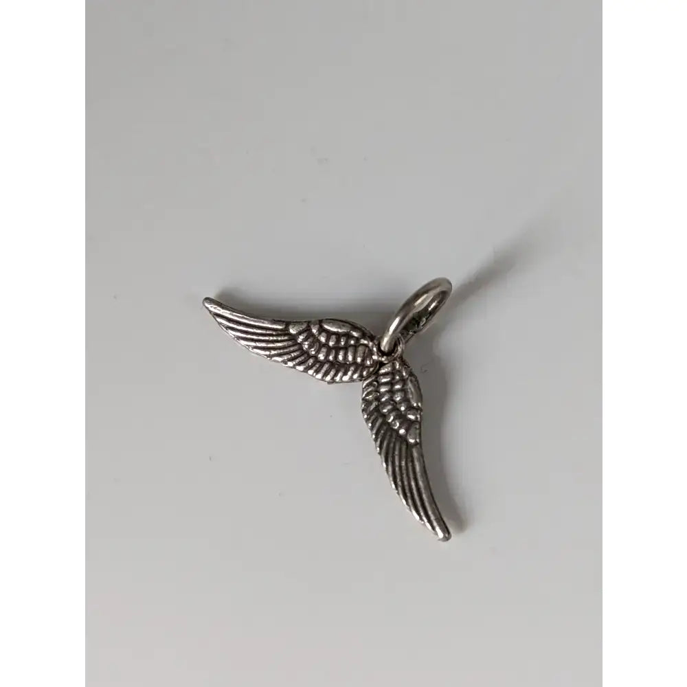 Silver steed angel wings silver pendant featuring a silver-toned charm with detailed feather texture and a small loop