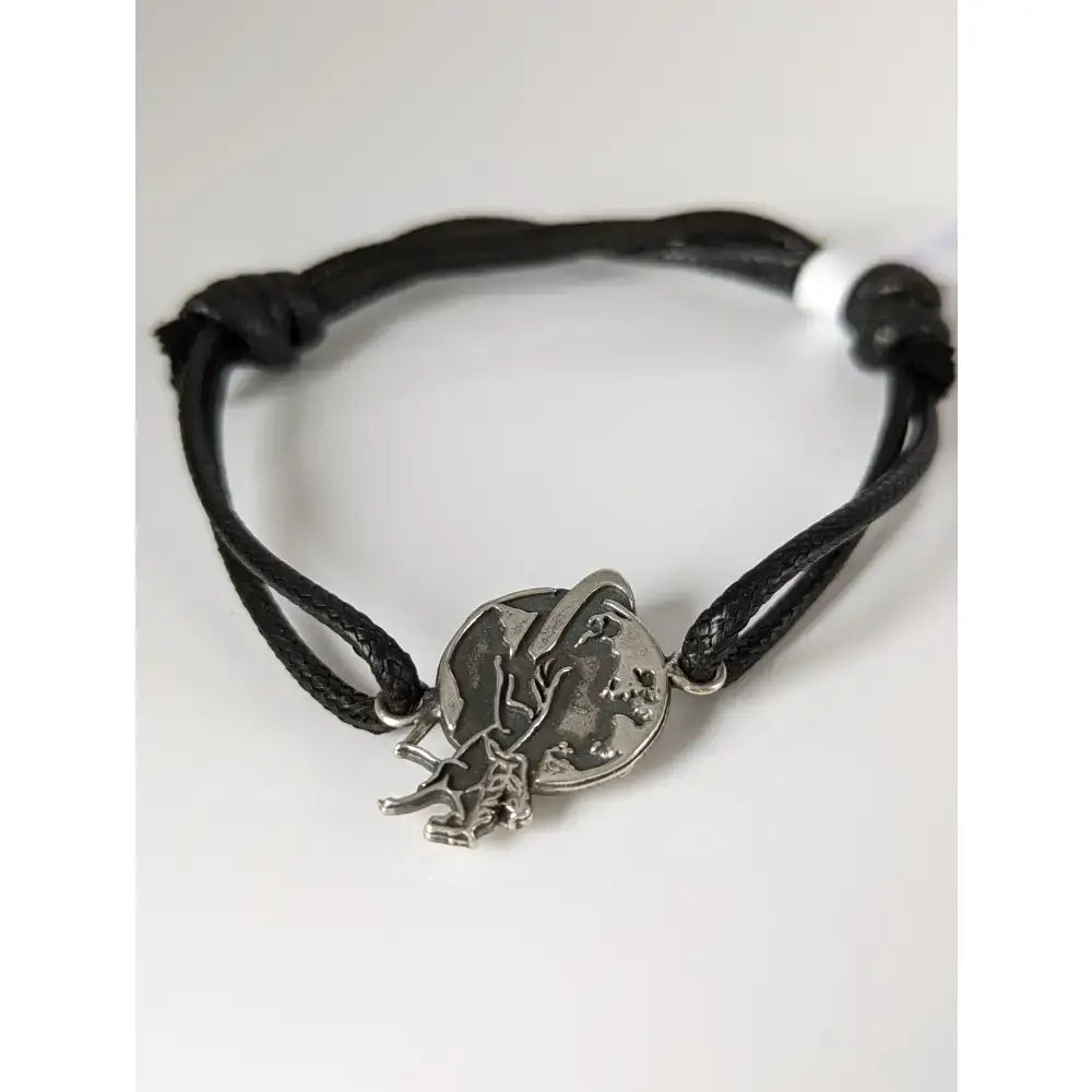 Black braided cord world bracelet with silver steed charm showing equestrian figure holding crescent moon