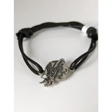 Black braided cord world bracelet with silver steed charm showing equestrian figure holding crescent moon