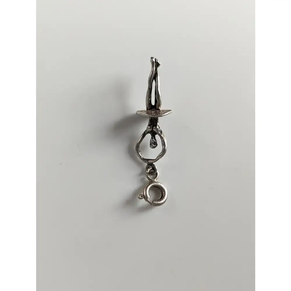 Silver charm featuring a silver steed ballet dancer acrobat on a balance beam with adjustable ring clasp
