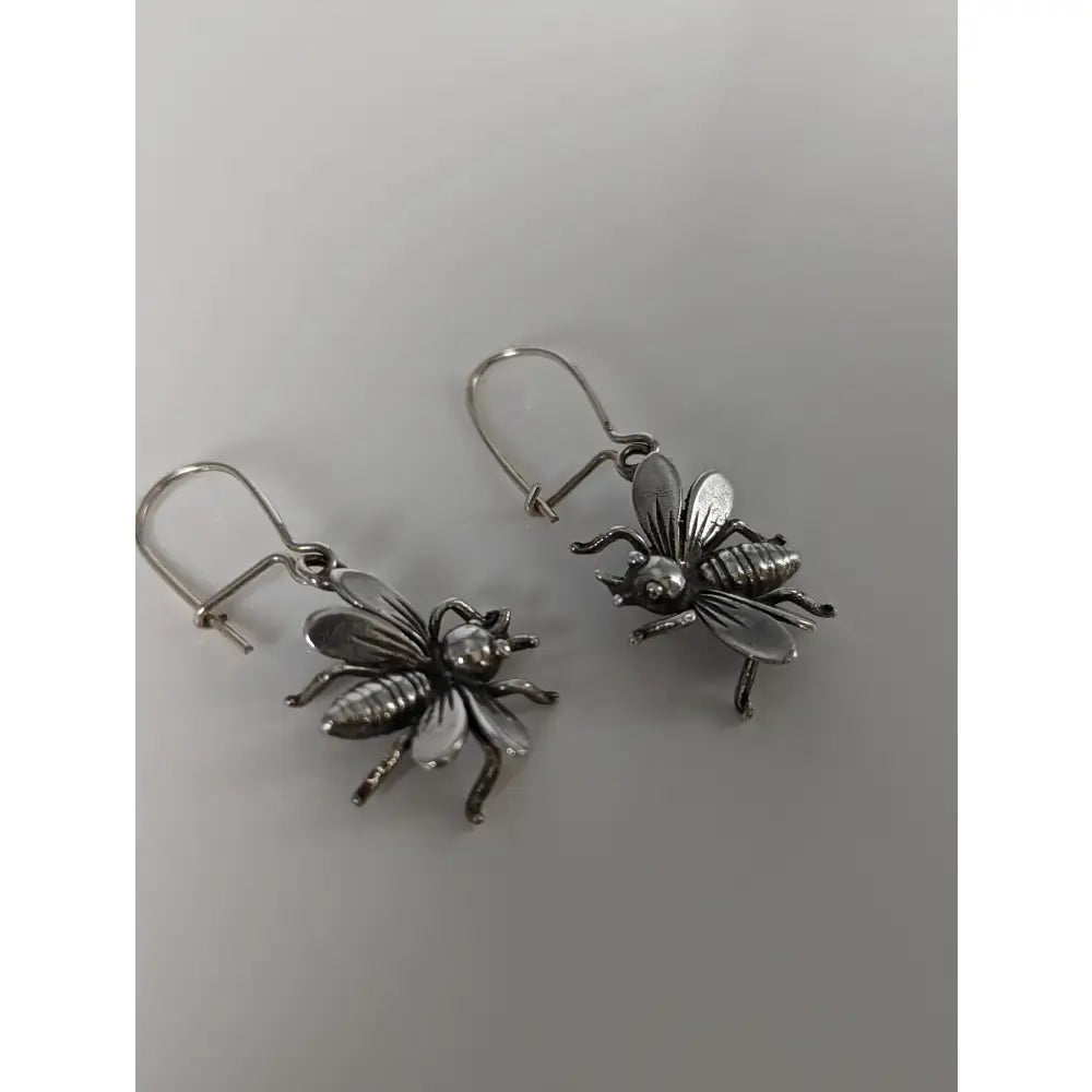 Silver steed bee dropped earrings featuring handmade silver jewelry with detailed wings and polished metallic finish