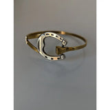Silver steed big horseshoe bangle in gold tone with sterling silver inner band and black dot detailing