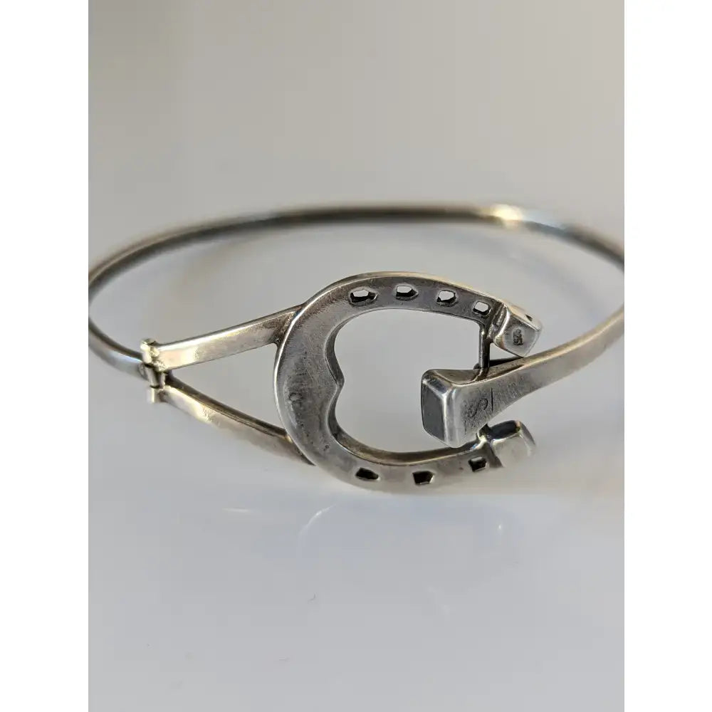 Silver steed big sterling silver horseshoe bangle with heart cutout and black dot details along the edge