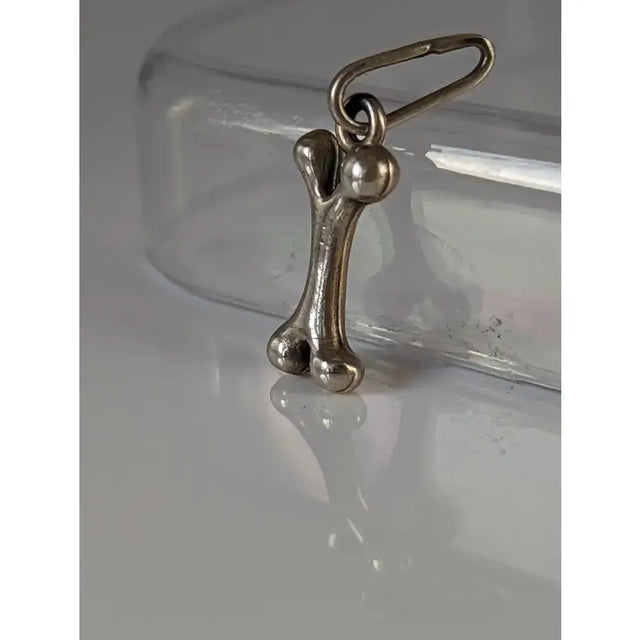 Silver steed bone silver pendant featuring a silver bone shaped charm with a loop for attaching as a silver pendant