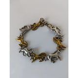 Silver steed galloping horses bracelet with alternating silver and brass horse charms in a dynamic design