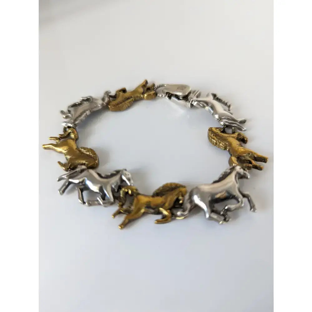 Silver steed silver and brass galloping horses bracelet with two-tone metallic horse figures in a running pose