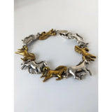 Silver steed silver and brass galloping horses bracelet with two-tone metallic horse figures in a running pose