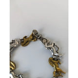 A two-tone silver steed galloping horses bracelet with alternating silver and brass charms and a magnetic clasp